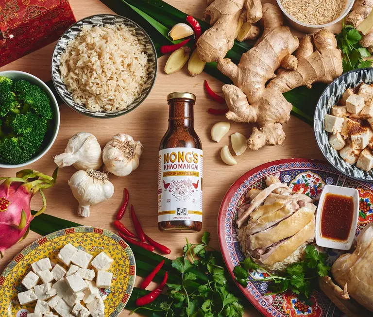 Nong's ingredients and sauce bottles arranged on a table: rice, ginger, garlic, chillies, tofu and mushrooms.