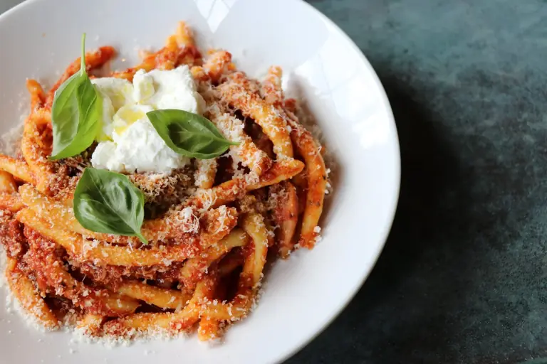 A bowl of pasta at Sorella: rigatoni in tomato sauce with basil and a spoonful of ricotta.