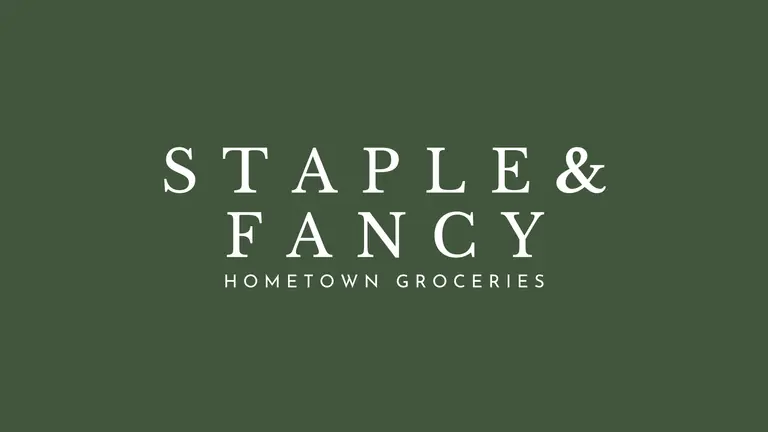 Staple & Fancy's wordmark: STAPLE & FANCY in white letterspaced capitals above HOMETOWN GROCERIES, on olive green.